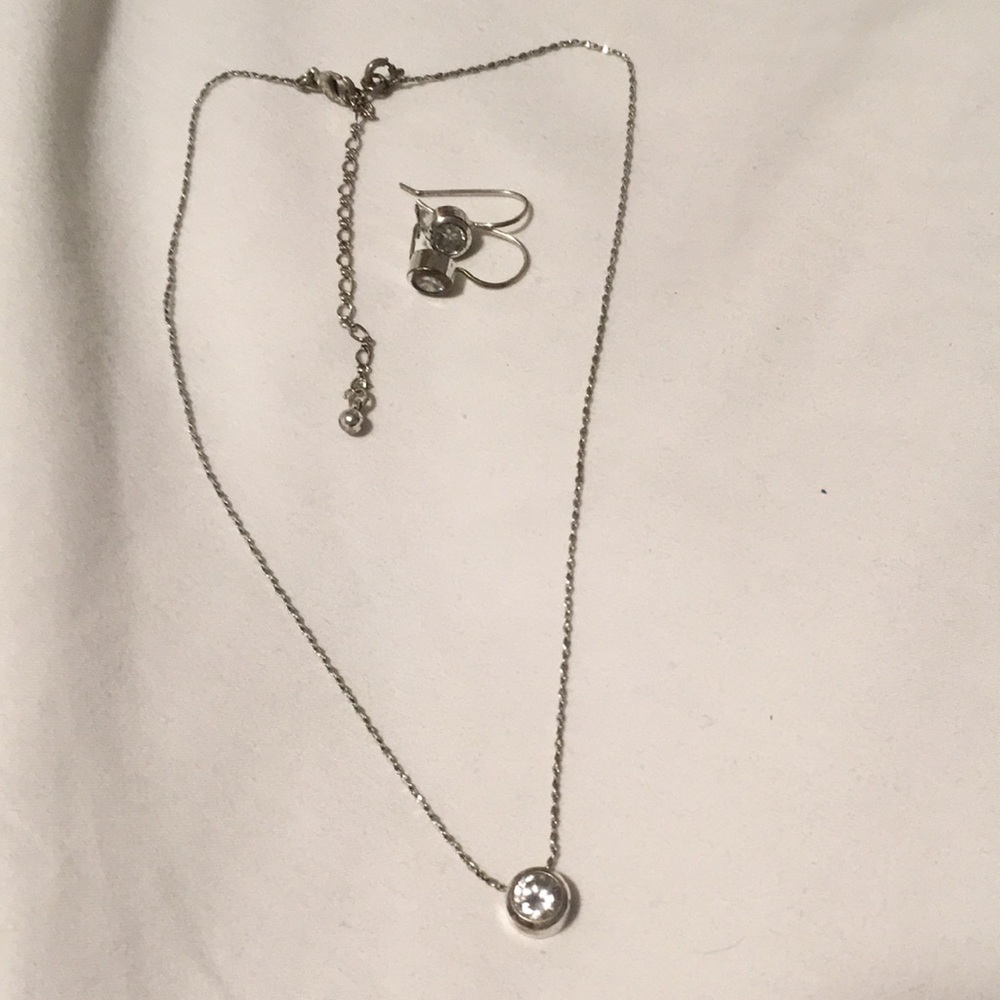 Avon pair of silver earrings and a necklace with white/clear round gem stone.